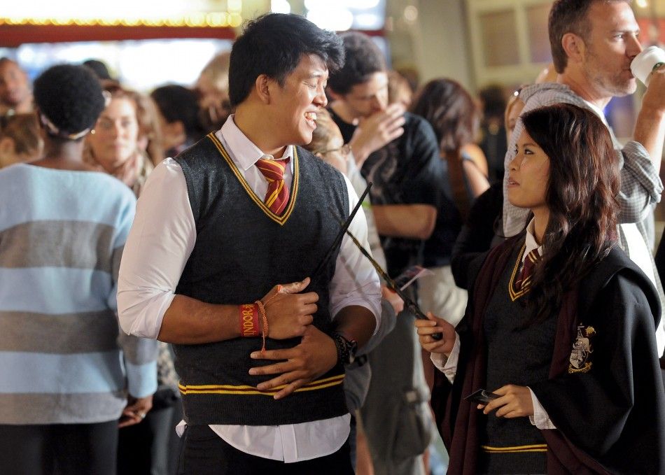 Niko Evangelista L and Windy Rapanakul R join the crowds lined up to be the first to see the new Harry Potter movie quotHarry Potter and the Deathly Hallows - Part 2quot at a minute after midnight in the Hollywood area of Los Angeles, California