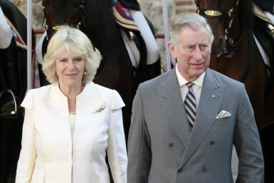 Britain&#039;s Prince Charles walks next to his wife Camilla