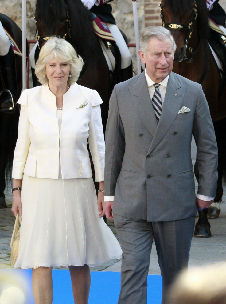 Britain&#039;s Prince Charles walks next to his wife Camilla