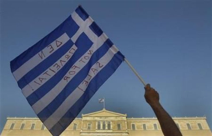 A protester waves a Greek flag during a rally against austerity economic measures and corruption in Athens