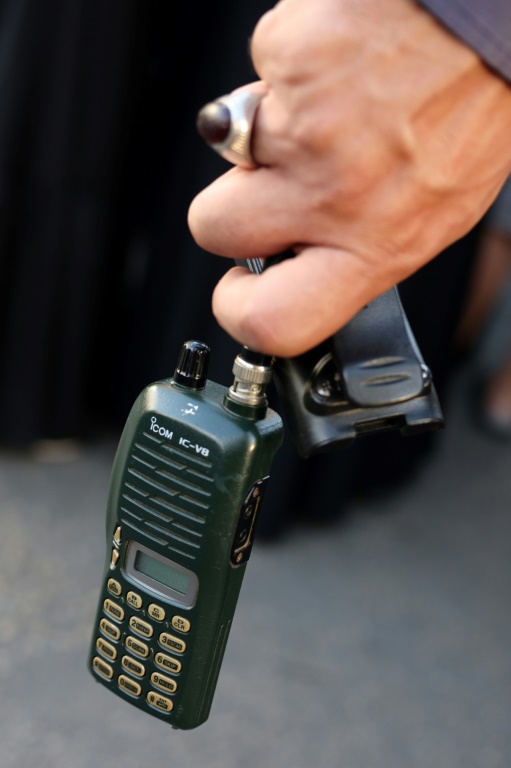 https://d.ibtimes.com/en/full/4549287/man-holds-walkie-talkie-after-removing-its-battery-during-funeral-beirut.jpg