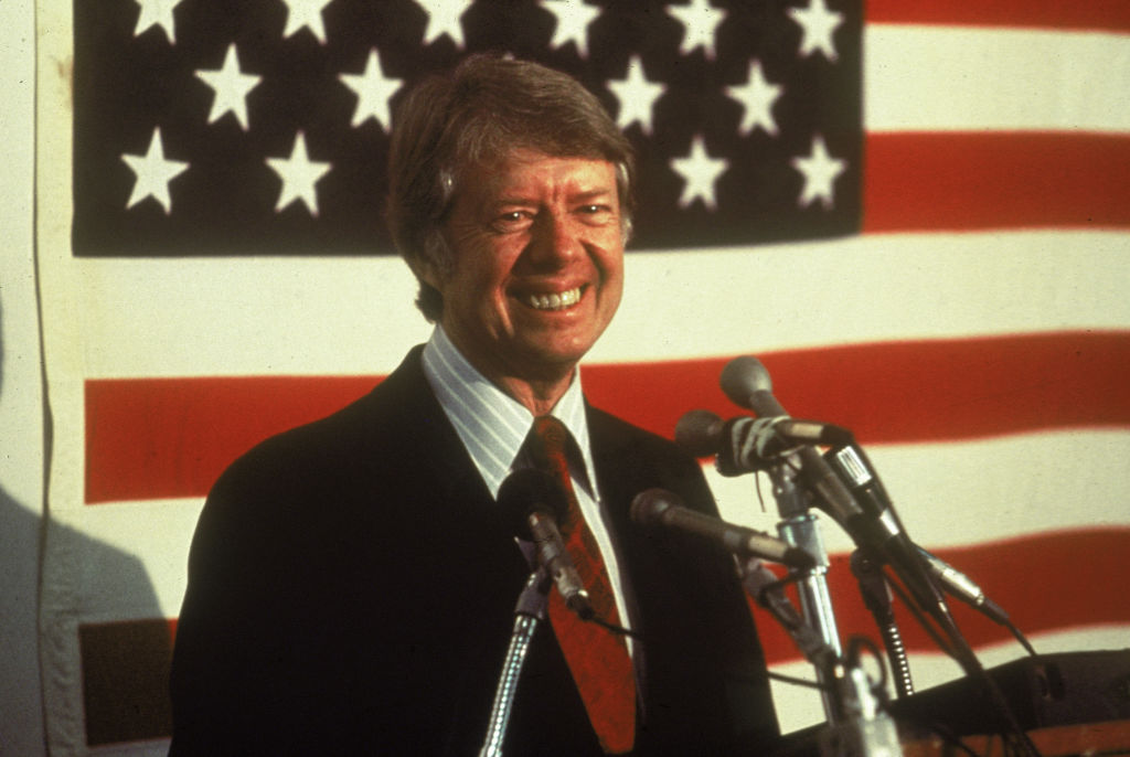 https://d.ibtimes.com/en/full/4550701/jimmy-carter-front-flag.jpg