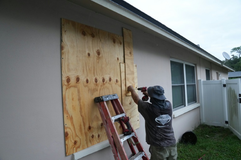 https://d.ibtimes.com/en/full/4552452/resident-boards-his-windows-palm-harbor-florida-ahead-hurricane-milton.jpg