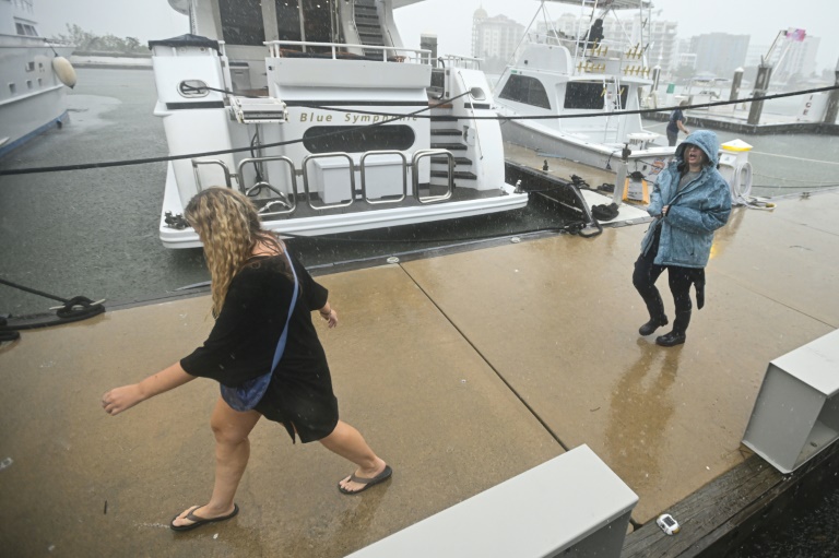 https://d.ibtimes.com/en/full/4553085/people-walk-along-marina-sarasota-florida-powerful-hurricane-milton-nears-coast.jpg