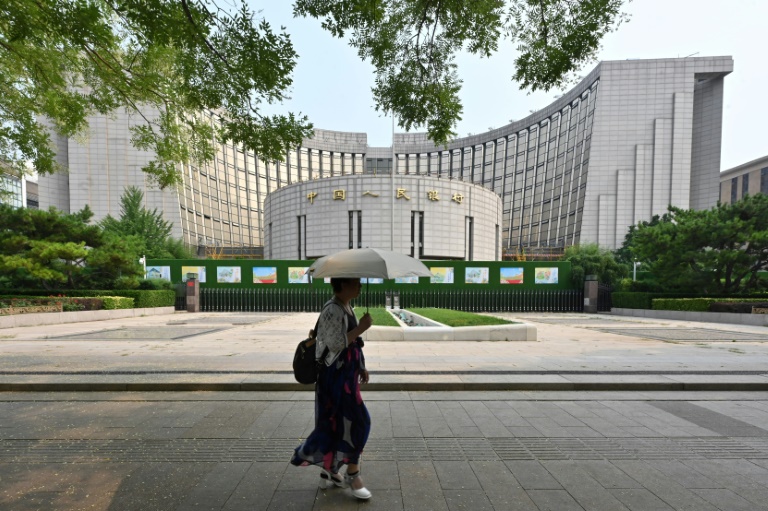 https://d.ibtimes.com/en/full/4553103/woman-walks-past-headquarters-peoples-bank-china-countrys-central-bank-beijing-july-9.jpg