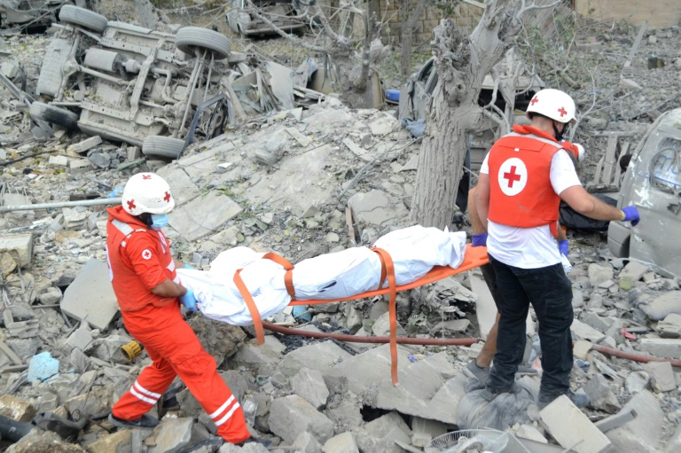 https://d.ibtimes.com/en/full/4554315/paramedics-carry-body-rubble-site-israeli-airstrike-aito.jpg