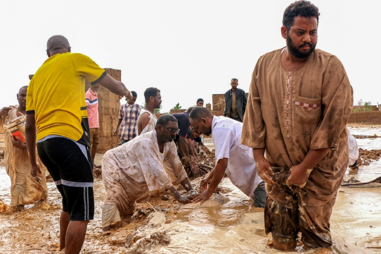 https://d.ibtimes.com/en/full/4556061/men-building-make-shift-levee-amid-floods-messawi-sudan-earlier-this-year.jpg