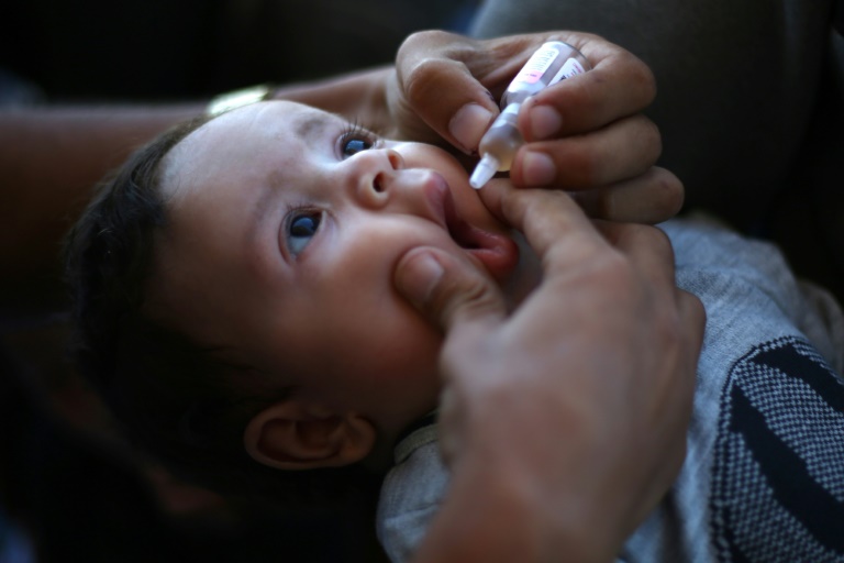 https://d.ibtimes.com/en/full/4556141/medic-administers-polio-vaccine-palestinian-child-khan-yunis-southern-gaza-strip.jpg