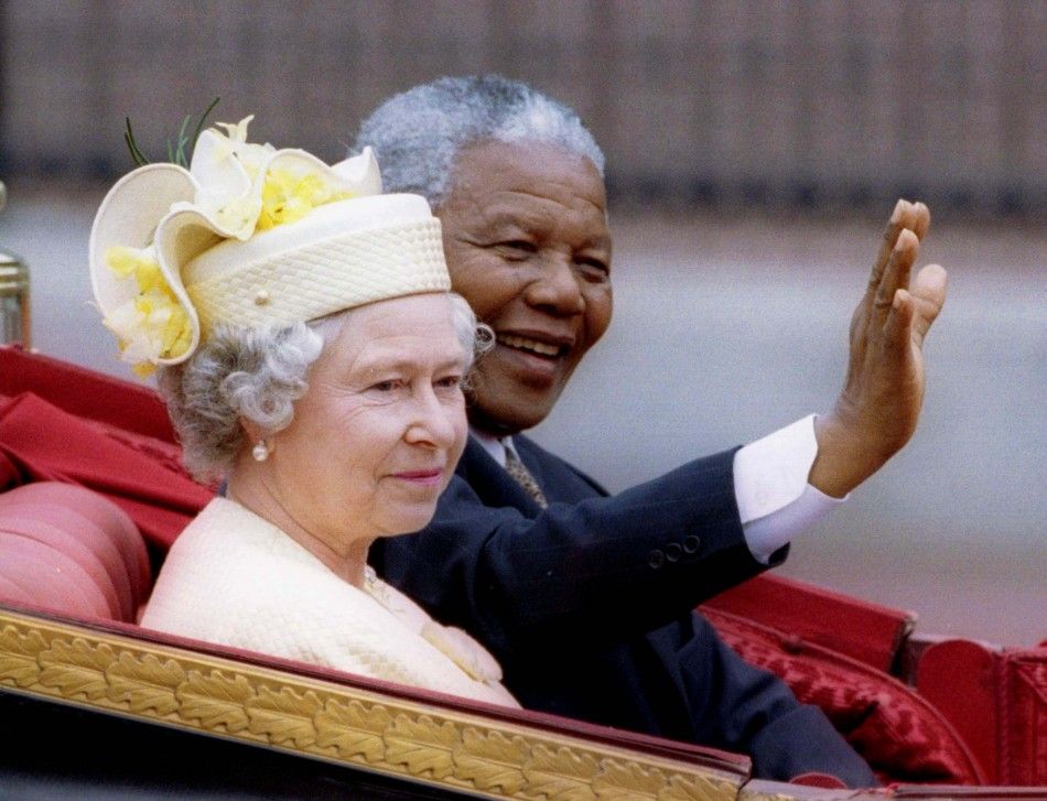 Nelson Mandela and Queen Elizabeth II ride in a carriage outside Buckingham Palace