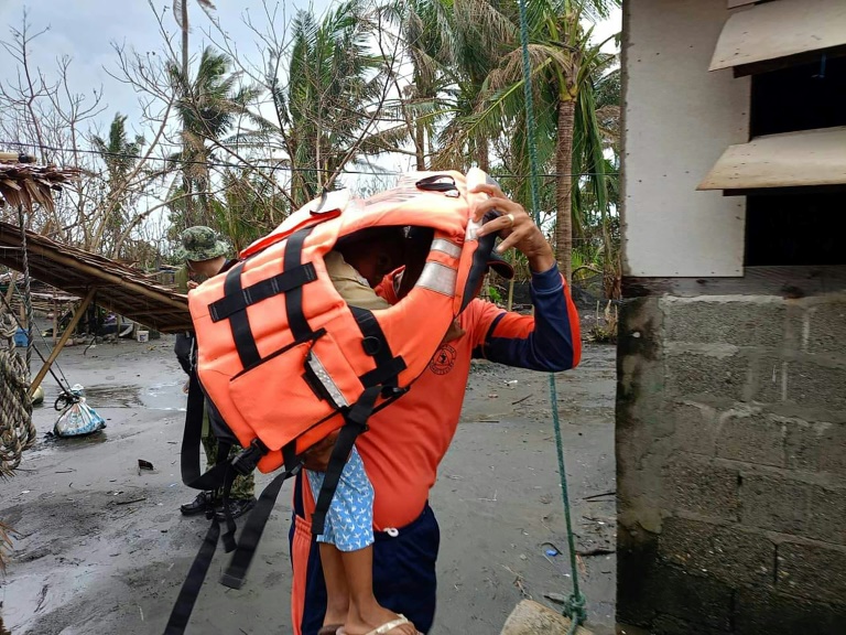 https://d.ibtimes.com/en/full/4561926/rescuer-carries-young-resident-during-forced-evacuation-operation-northern-philippines-ahead.jpg