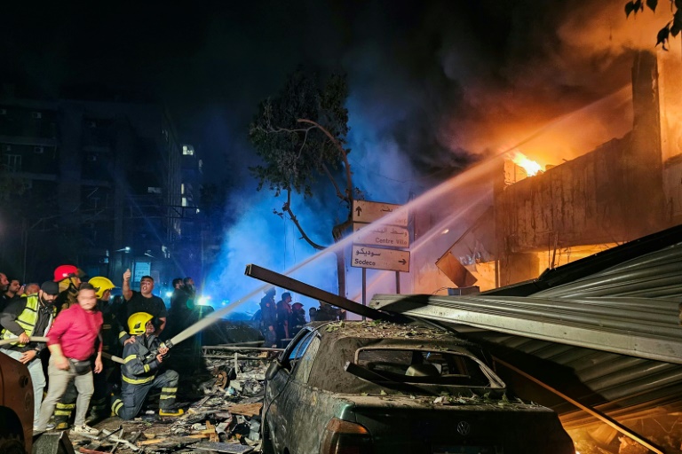 https://d.ibtimes.com/en/full/4562660/firefighters-douse-flames-site-israeli-strike-building-lebanese-capital.jpg