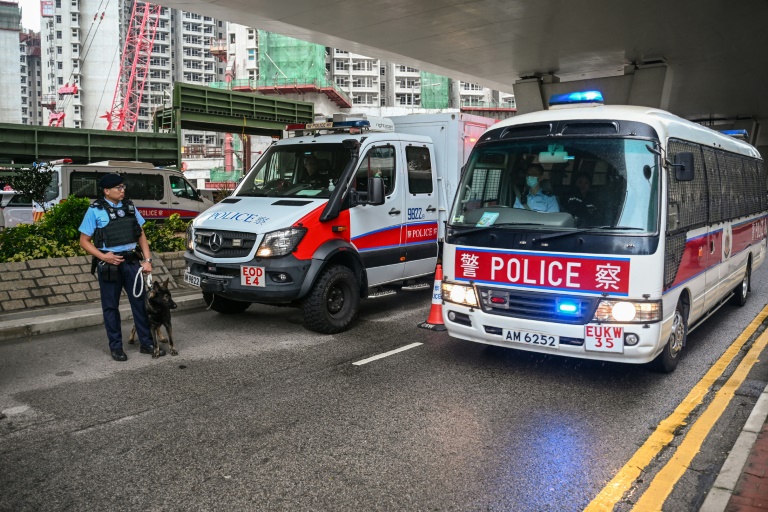 https://d.ibtimes.com/en/full/4562862/police-keep-watch-outside-west-kowloon-magistrates-court-hong-kong-during-sentencing-citys.jpg