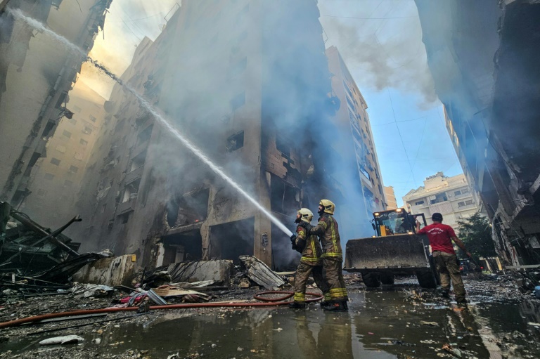 https://d.ibtimes.com/en/full/4563602/firefighters-battle-flames-buildings-hit-israeli-air-strike-that-targeted-neighbourhood-haret.jpg