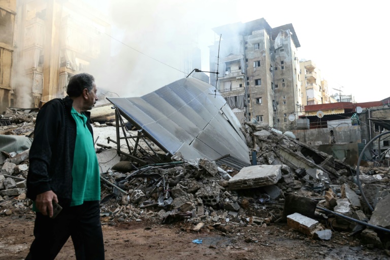 https://d.ibtimes.com/en/full/4563972/man-walks-past-rubble-building-levelled-israeli-air-strike-beiruts-southern-suburbs.jpg