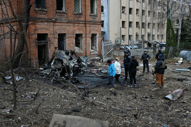 https://d.ibtimes.com/en/full/4564268/ukrainian-law-enforcement-officers-local-residents-stand-among-debris-courtyard-damaged.jpg