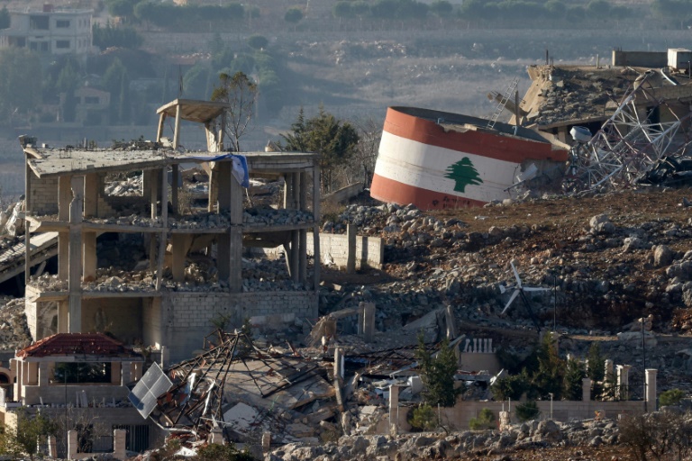 https://d.ibtimes.com/en/full/4564750/israeli-flag-hangs-destroyed-building-while-lebanese-flag-painted-another-southern-lebanese.jpg