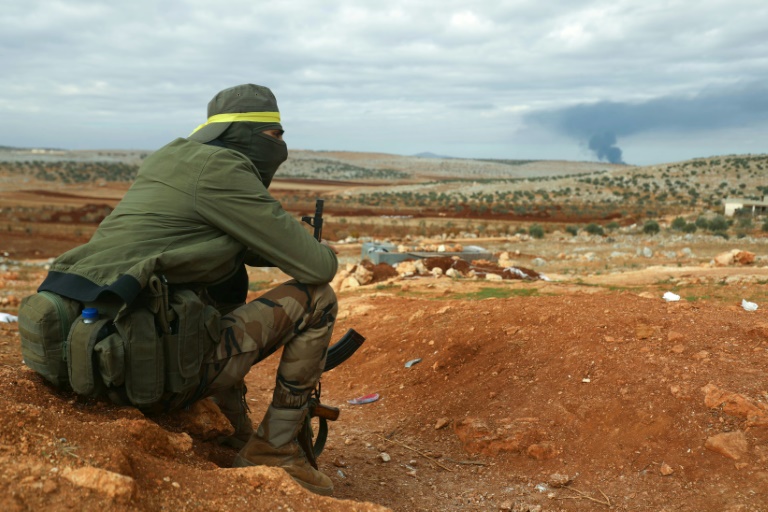 https://d.ibtimes.com/en/full/4565172/fighter-hayat-tahrir-al-sham-hts-mans-position-eastern-outskirts-atarib-town-syrias.jpg