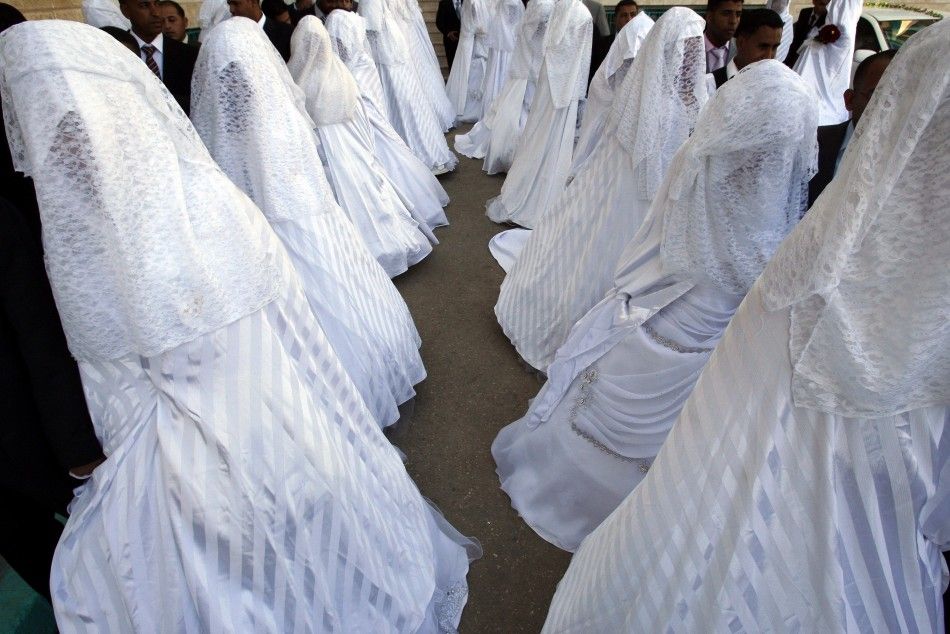 Brides and grooms pose during a mass wedding ceremony in Amman July 15, 2011. A Jordanian Islamic charity organized a mass wedding for 72 couples unable to afford expensive ceremonies