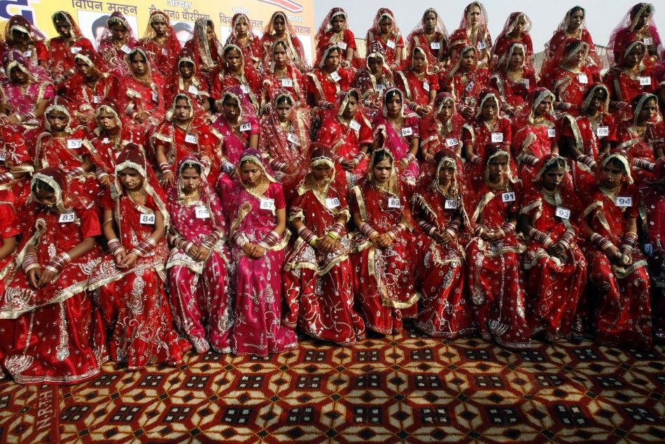Hindu brides sit during a mass wedding ceremony in Noida December 26, 2009. A total of 101 couples from the city took wedding vows on Saturday during the mass wedding ceremony organised by a Hindu voluntary organisation, organisers said