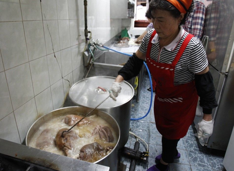 Woman cooks dog meat