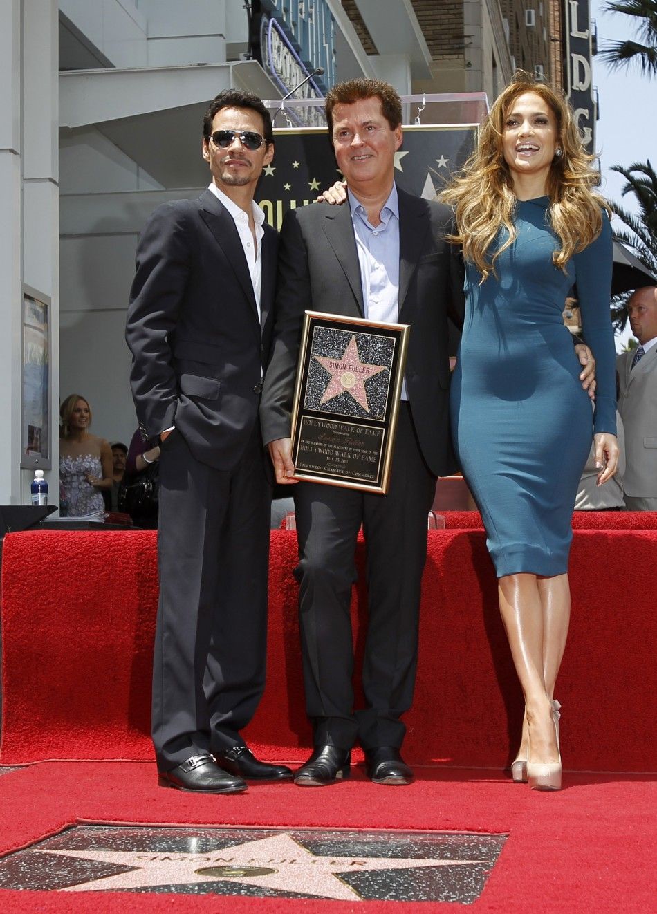 Fuller poses with Lopez and her husband Anthony after he was honored with a star on the Walk of Fame in Hollywood 23052011