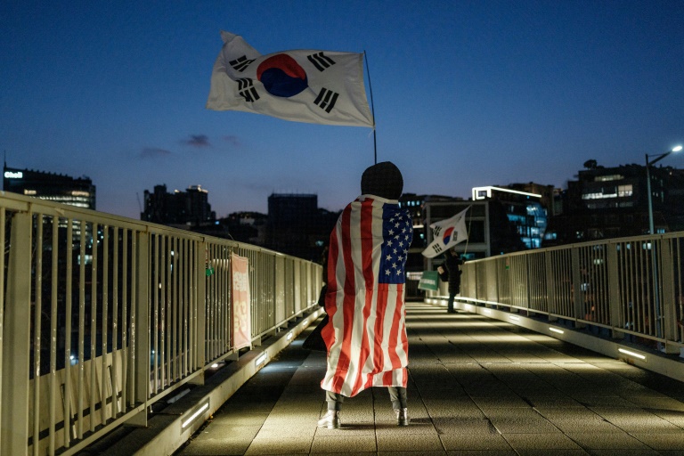 https://d.ibtimes.com/en/full/4574210/supporter-impeached-south-korean-president-yoon-suk-yeol-draped-us-flag-waves-south-koreas.jpg