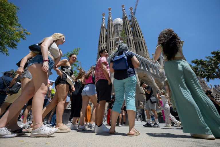 https://d.ibtimes.com/en/full/4579079/tourists-stand-front-sagrada-familia-basilica-barcelona-july-5-2024.jpg