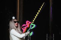 Singer Lady Gaga carries a pair of scissors during a ribbon cutting ceremony to launch Gaga&#039;s Workshop at Barneys department store in New York November 21, 2011.