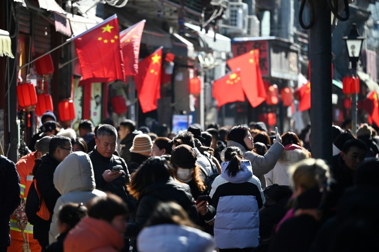 https://d.ibtimes.com/en/full/4580488/people-walk-below-chinese-flags-alley-near-popular-shopping-street-during-lunar-new-year.jpg