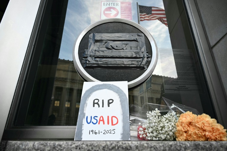 https://d.ibtimes.com/en/full/4581560/tributes-are-placed-beneath-covered-seal-us-agency-international-development-usaid.jpg