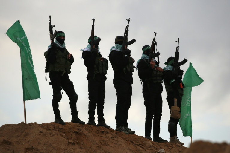 https://d.ibtimes.com/en/full/4583803/palestinian-hamas-militants-gather-site-handover-four-israeli-hostages-bodies.jpg