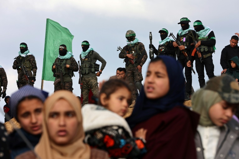 https://d.ibtimes.com/en/full/4584223/hamas-militants-gaza-residents-gathered-handover-hostages-bodies-khan-yunis-thursday.jpg