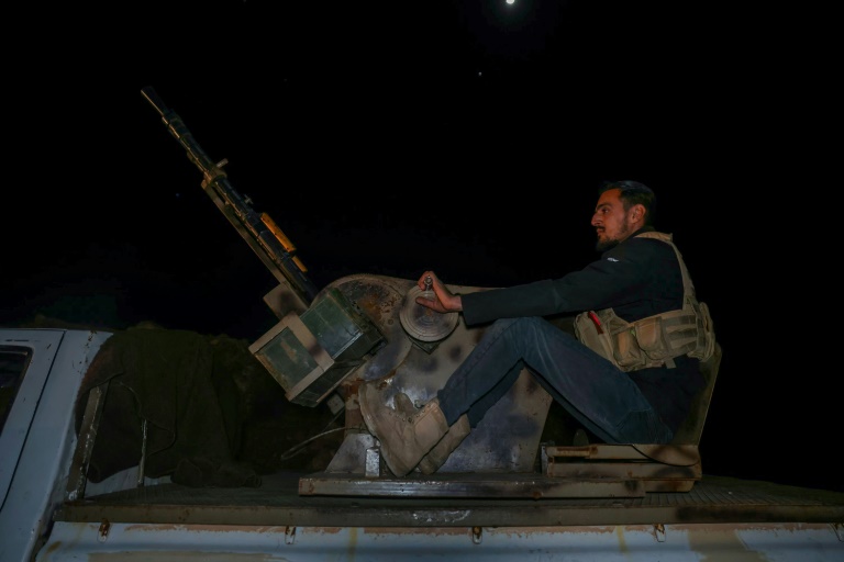 https://d.ibtimes.com/en/full/4585476/member-syrian-security-forces-mans-gun-back-pickup-truck-they-prepare-depart-al.jpg