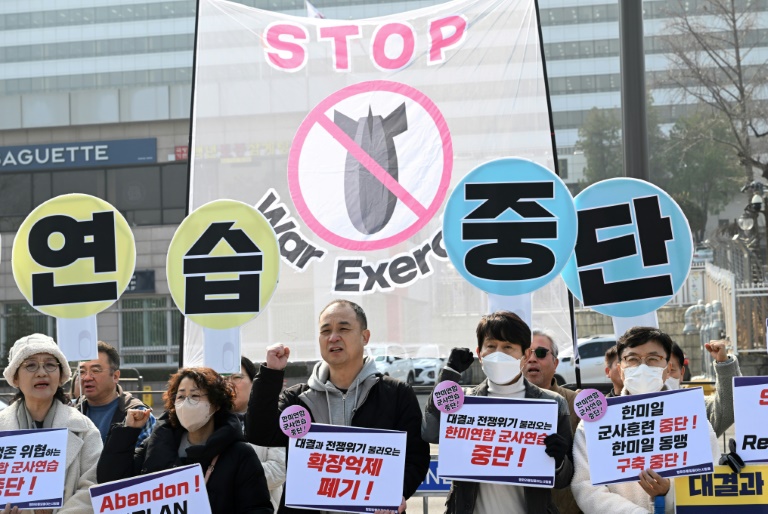 https://d.ibtimes.com/en/full/4586022/south-korean-protesters-hold-banners-that-collectively-read-stop-military-exercise-between-us.jpg