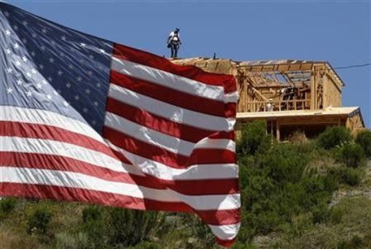 Workers build new homes on a hilltop in Carlsbad, California