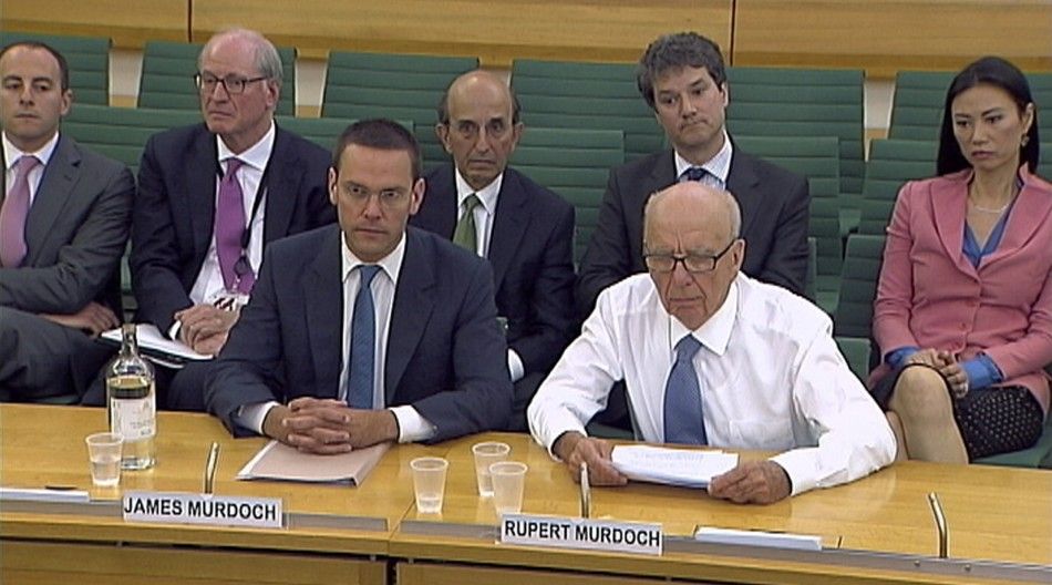 News Corp Chief Executive and Chairman Rupert Murdoch sits without his jacket after being attacked with a plate of white foam, during a parliamentary committee hearing at Portcullis House in London