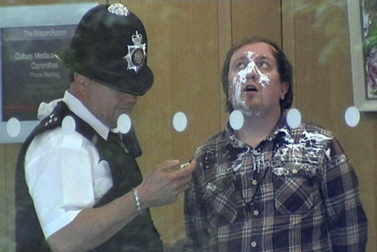 A man is held by police after he tried to attack News Corp Chief Executive and Chairman Rupert Murdoch during a parliamentary committee hearing on phone hacking at Portcullis House in London