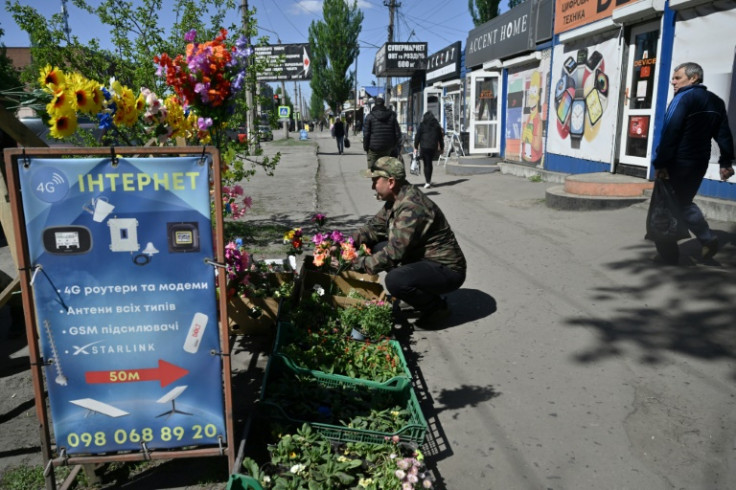 A local resident sells flowers in the town of Dobropillia, Donetsk region, amid the Russian invasion of Ukraine