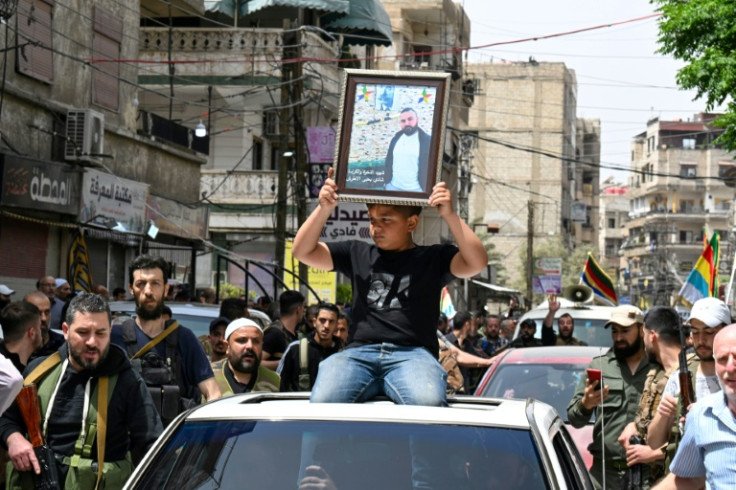 Members of the Druze community attend the funeral of seven people killed in clashes this week