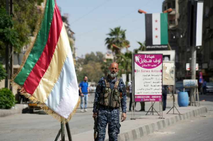 A member of the Druze security forces stands guard in Jaramana earlier this week