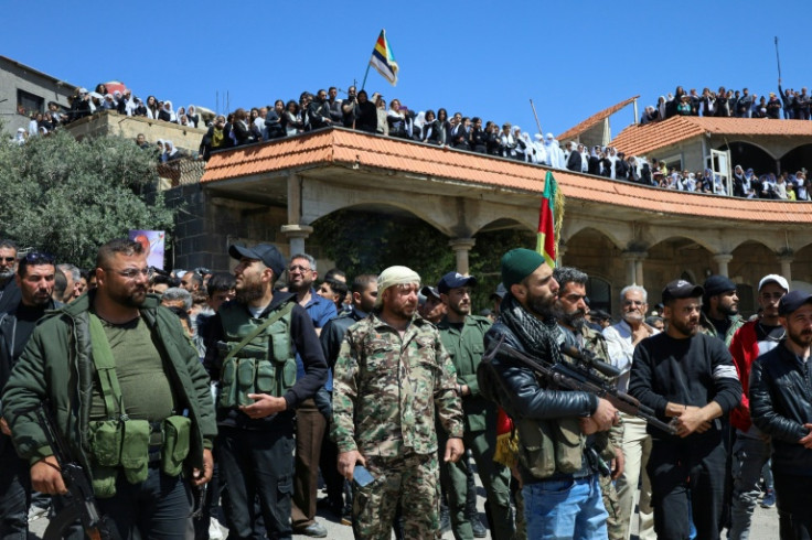 Armed Syrian Druze in the community's Sweida province heartland attend the funeral of comrades killed in sectarian clashes with loyalists of the Islamist-led government.