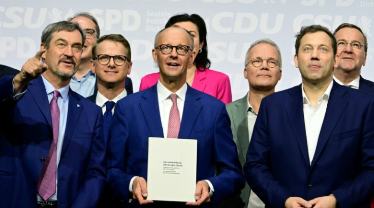 Merz, at the centre, is on Tuesday set to be sworn in as the new leader of Europe's biggest economy, ending half a year of political paralysis in Berlin