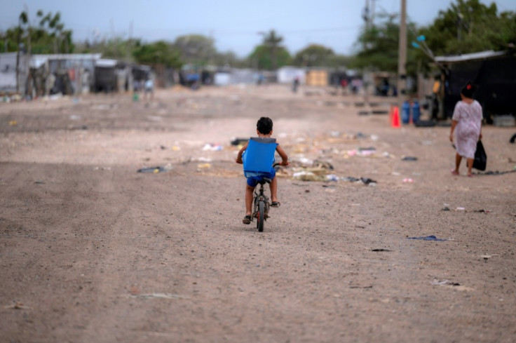 A child rides his bike in the camp