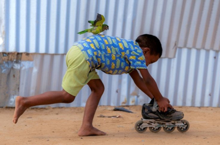 A child plays at the camp, where Save the Children has also recently had to cut back