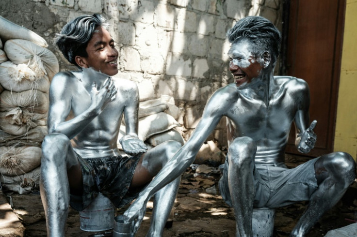 Painting their bodies silver has health risks, but it is one some feel is necessary to make ends meet as the cost of living worsens and jobs dwindle in Jakarta