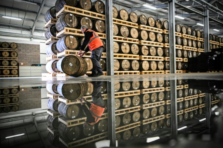 Distiller Donald MacLeod, 27, rolls a barrel of whisky in the warehouse on the island where he has bought a house and hopes to stay