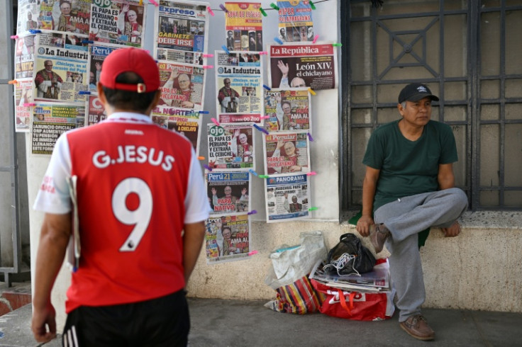 A man looks at the newspapers near Chiclayo's cathedral, northern Peru on May 9, 2025. US-born pontiff Leo XIV, close to Pope Francis, became a Peruvian national in 2015 and devoted more than 20 years as a missionary in the Andean country.