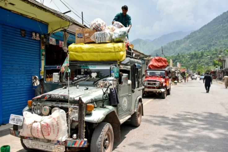 A resident loads food and supplies on his vehicle as the market reopens in Chakothi after the ceasefire