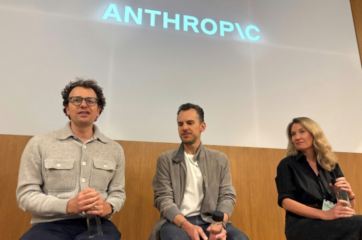 Anthropic CEO Dario Amodei (l) says people are going to eventually have to cope with AI systems being able to handle just about any task a human can handle