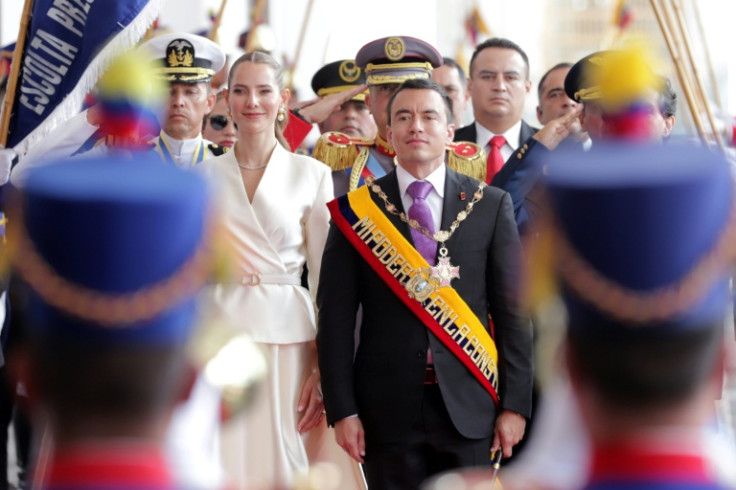 Ecuador's re-elected President Daniel Noboa (C) and his wife, First Lady Lavinia Valbonesi (L), receive honors upon their entrance to the Carondelet Palace after his inauguration at the National Assembly in Quito on May 24, 2025